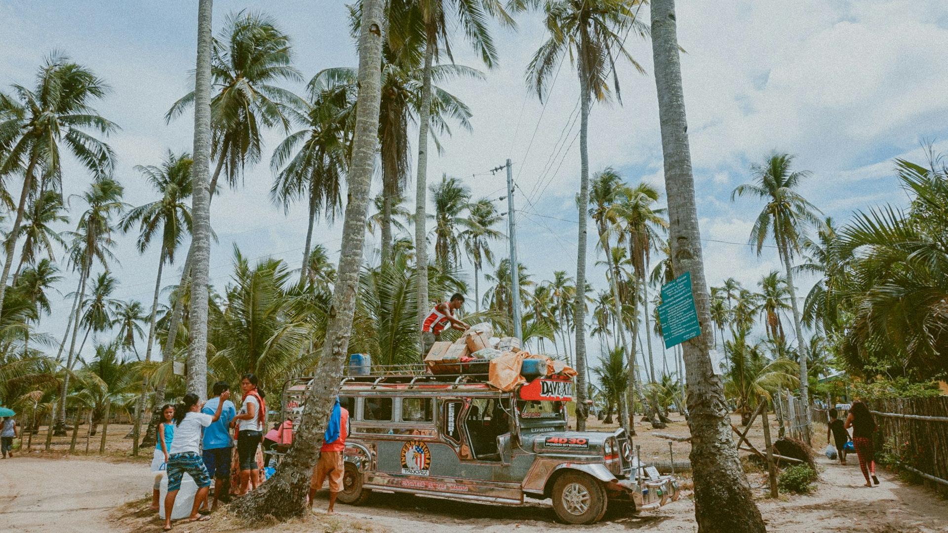 man on top of jeepny